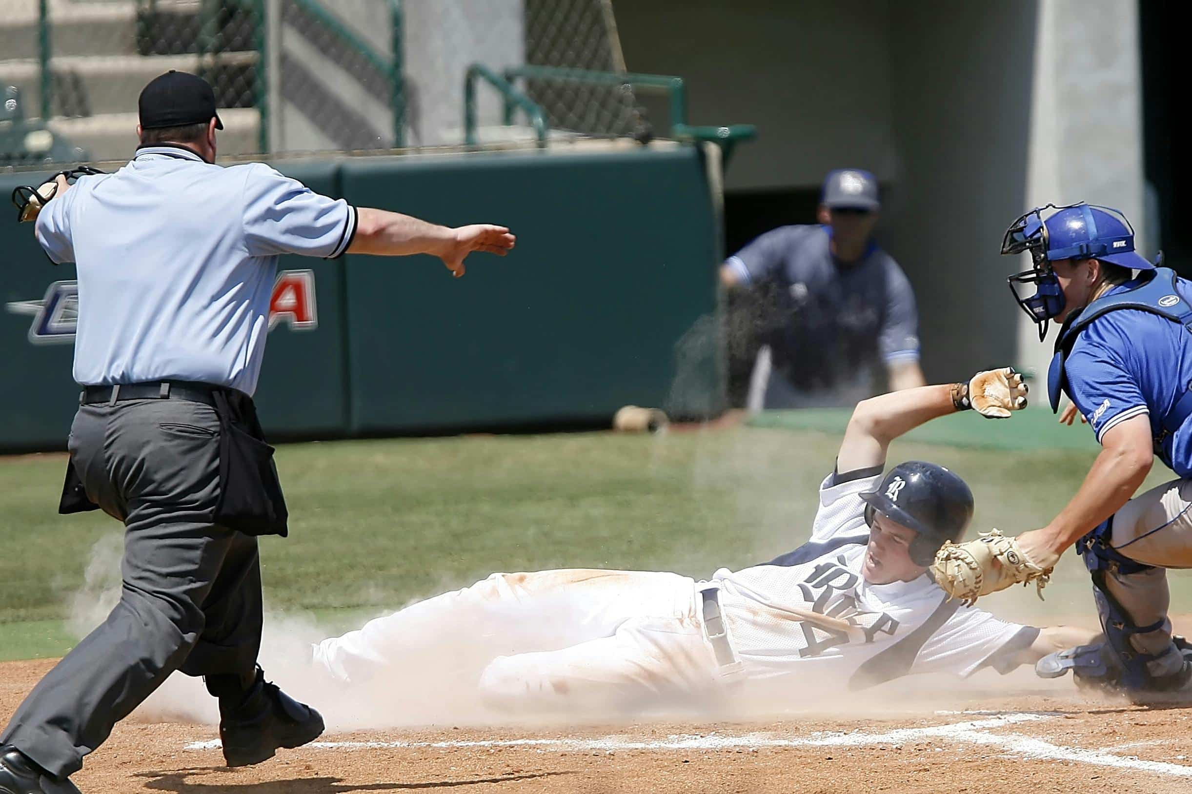 Baseball player sliding into home