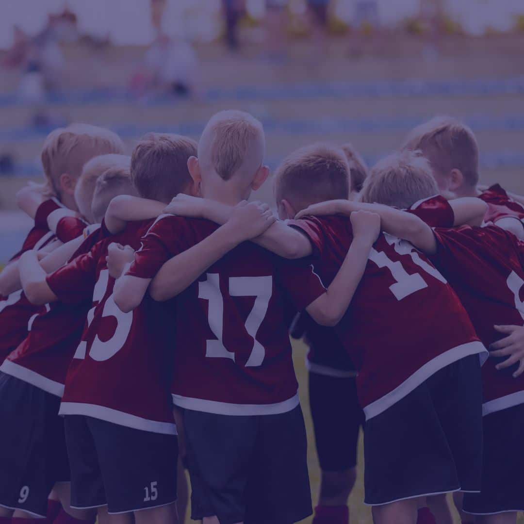 Group of young soccer players in huddle